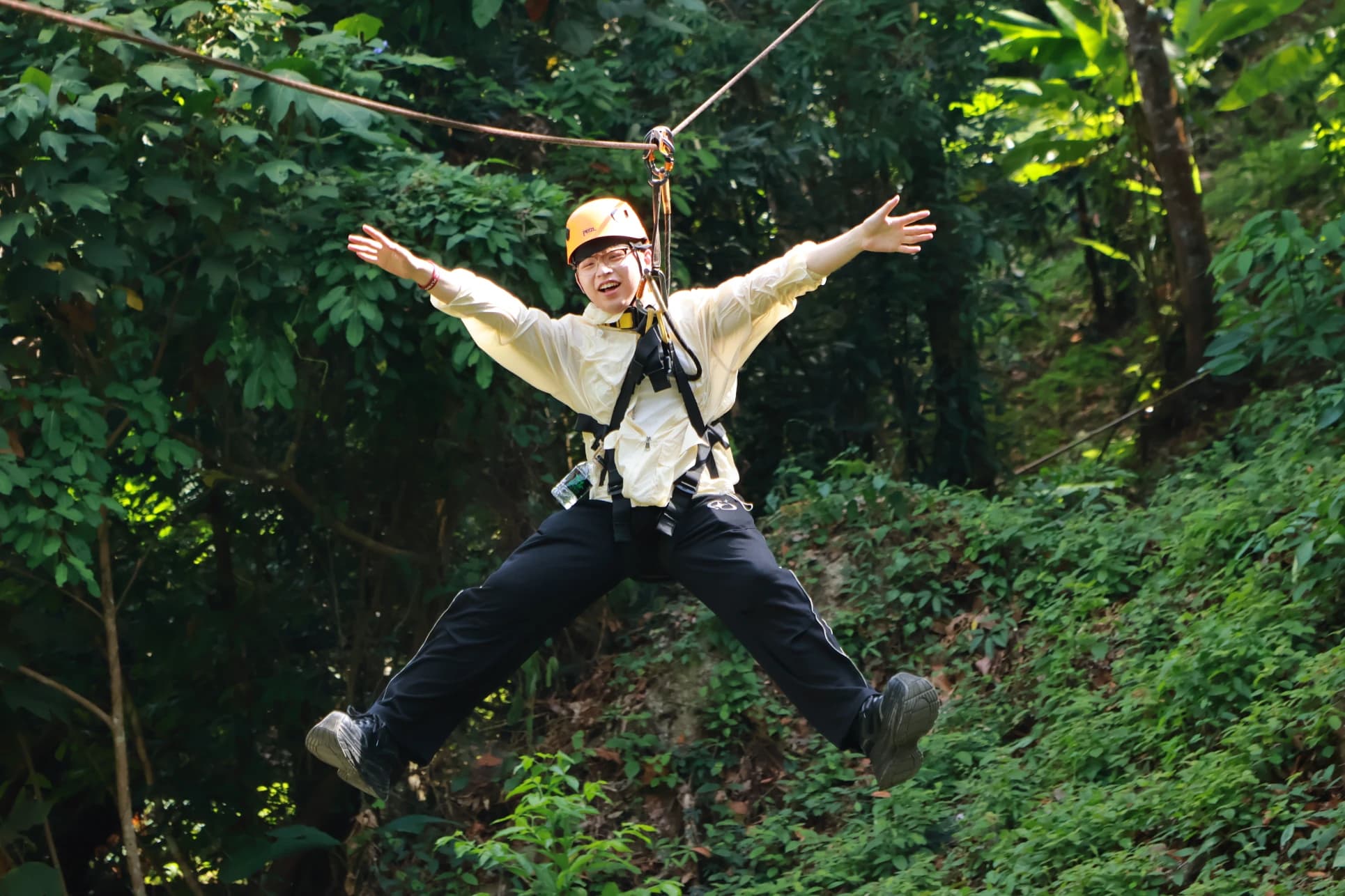 Zipline crossing through Flying Hanuman's rainforest canopy in Phuket