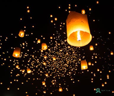 Floating lanterns rising during Yi Peng in Chiang Mai